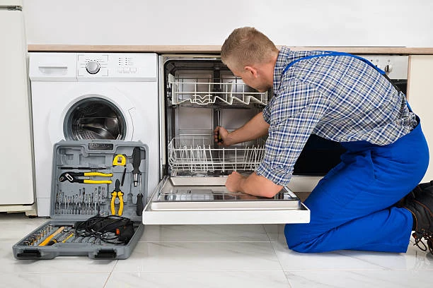 Technician inspecting dishwasher racks and interior components